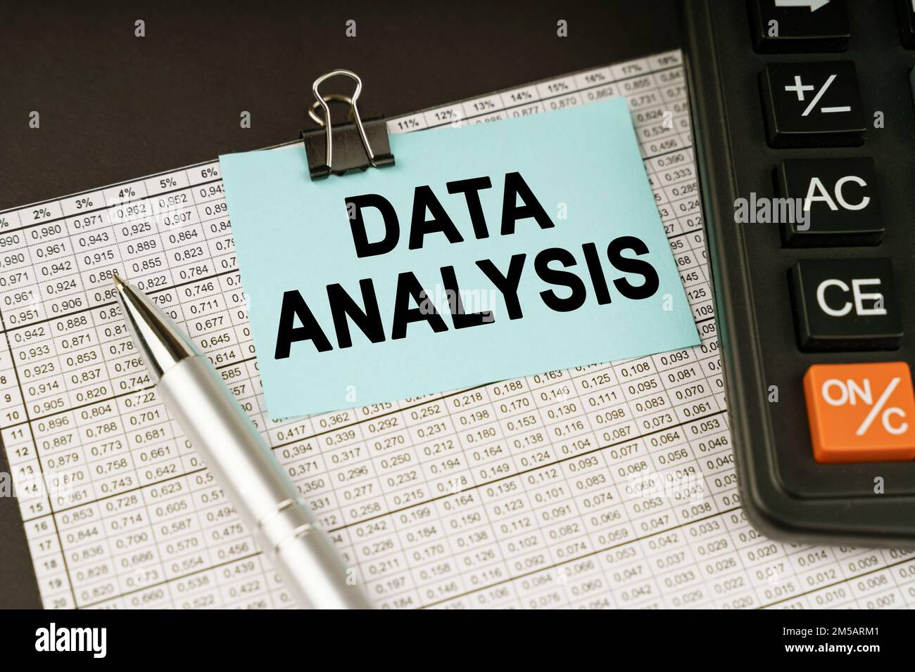 Business concept. On financial reports lies a calculator, a pen and a sticker with the inscription - DATA ANALYSIS Stock Photo