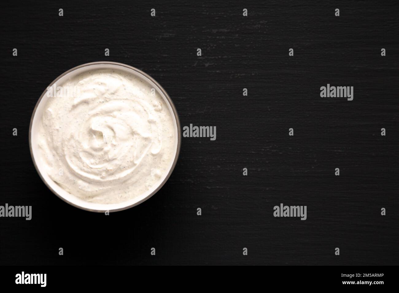 Homemade Ranch Dressing in a Bowl on a black background, top view. Flat ...