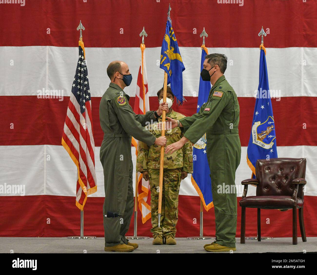 Col. Matthew McDonough (left), District of Columbia Air National Guard passes the unit guidon to Lt. Col. Michael T. McFarland, as McFarland formally assumes command of the 201st Airlift Squadron in a ceremony at Joint Base Andrews, Feb. 17th, 2022. The 201st is responsible for the unique, high-visibility of providing executive travel for U.S. military and political leaders worldwide, McFarland said in his remarks. Stock Photo