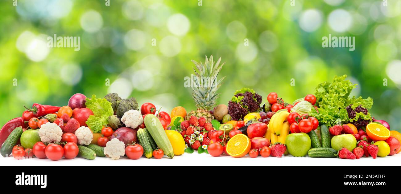 Collage fresh colored vegetables, fruits, berries on green background. Healthy food concept Stock Photo
