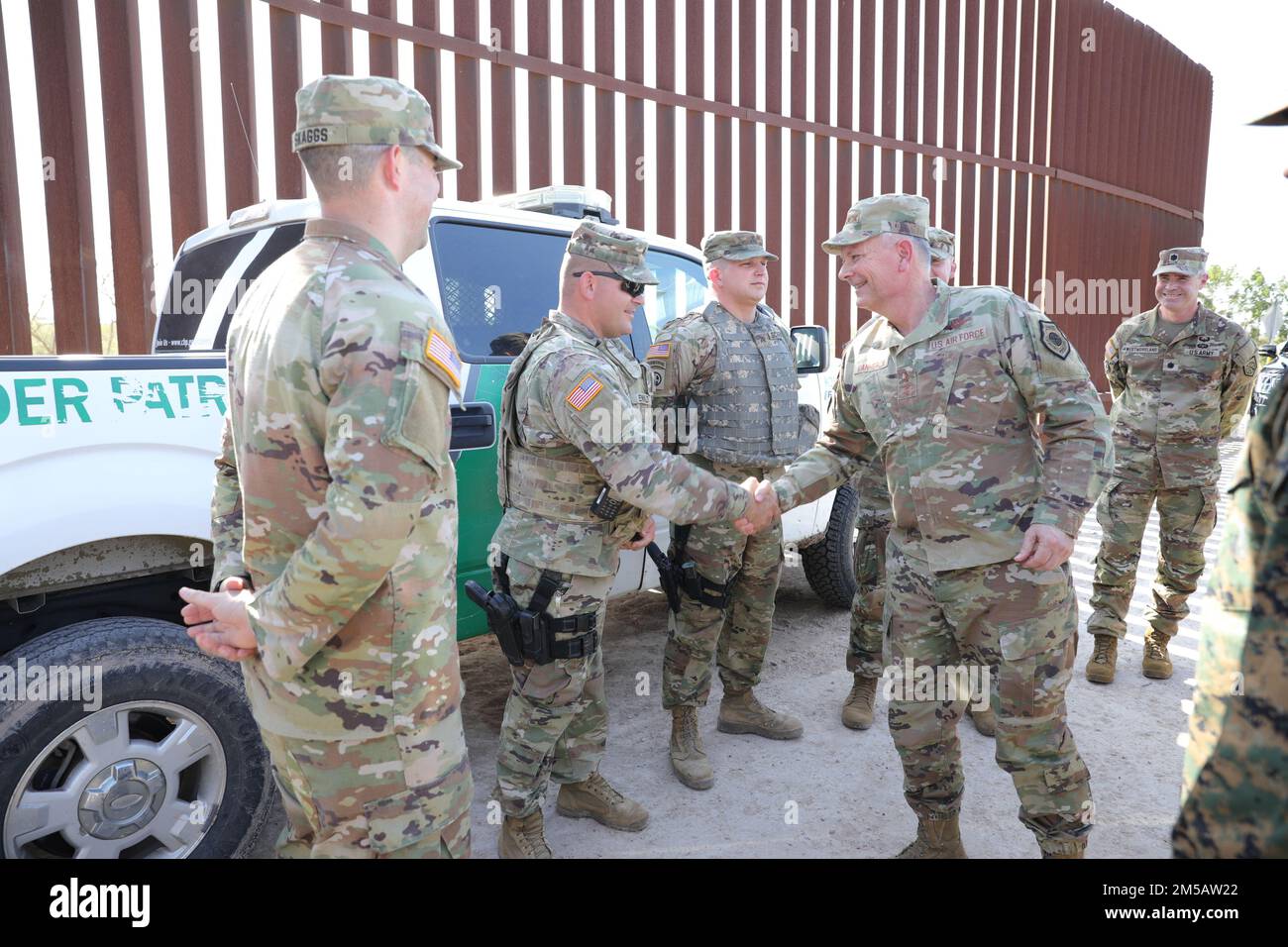 U.S. Air Force Gen. Glen VanHerck, Commander, North American Aerospace Defense Command and U.S. Northern Command, presents a challenge coin to Sgt. David Ewald of the Missouri National Guard’s 3175th Chemical Company currently deployed to McAllen, Texas, Feb. 7, 2022. Ewald, one of the National Guard service members deployed in an active-duty status under USNORTHCOM, was recognized by Gen. VanHerck for accomplishments during his deployment in support of the Southwest border mission. U.S. Northern Command is providing Mobile Surveillance Camera operators, Intelligence analysts, and aviation sup Stock Photo