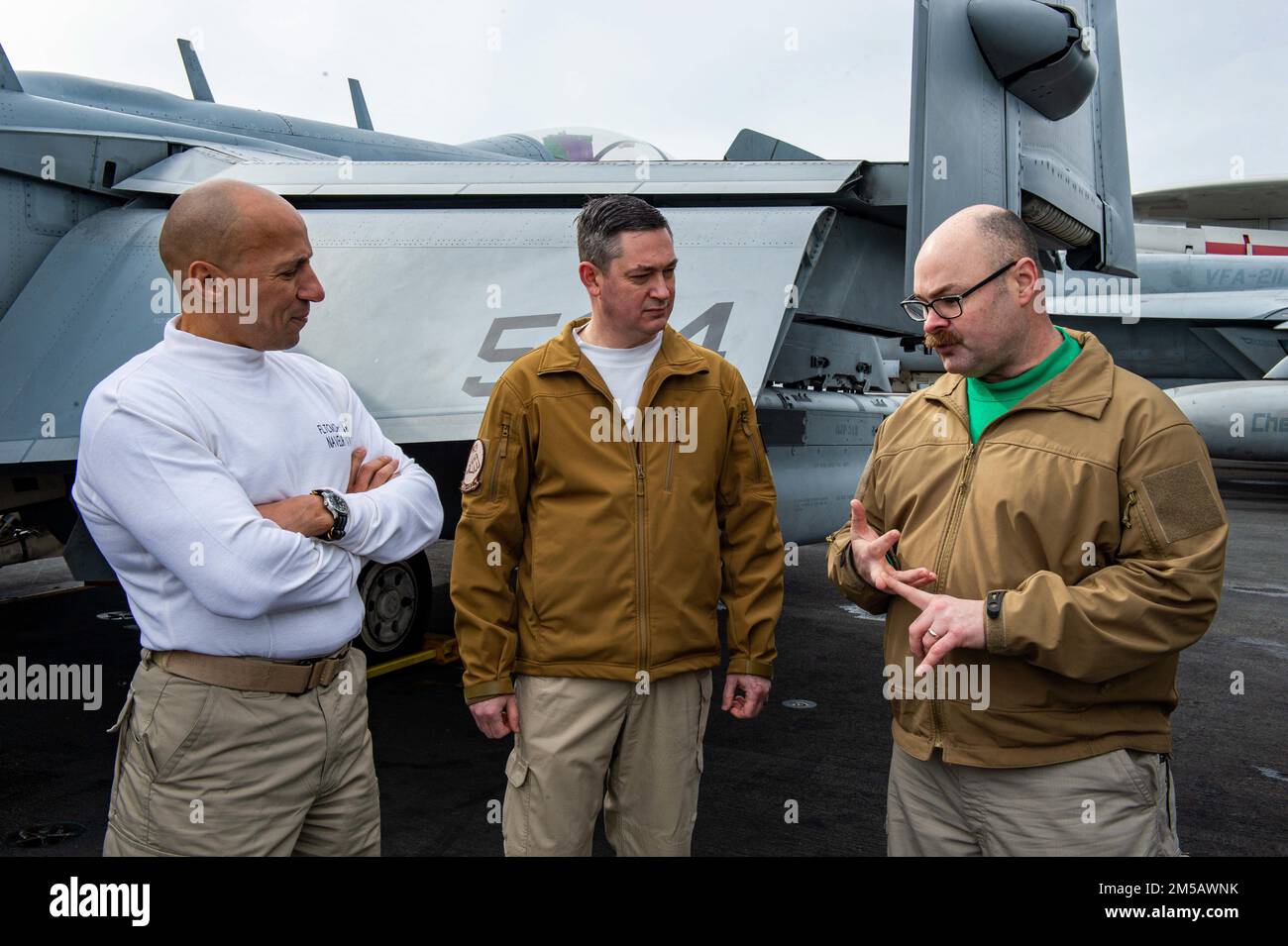 220217-N-YP095-2094 MEDITERRANEAN SEA (Feb. 17, 2022) Fleet Master Chief Derrick Walters, fleet master chief of U.S. Naval Forces Europe and Africa, speaks with Sailors, assigned to the 'Rooks' of Electronic Attack Squadron (VAQ) 137, on the flight deck of the Nimitz-class aircraft carrier USS Harry S. Truman (CVN 75), Feb. 17, 2022. The Harry S. Truman Carrier Strike Group is on a scheduled deployment in the U.S. Sixth Fleet area of operations in support of naval operations to maintain maritime stability and security, and defend U.S., allied and partner interests in Europe and Africa. Stock Photo