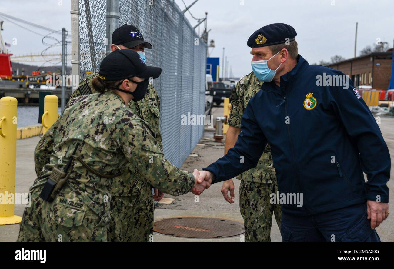 220217-N-MQ631-1017 GROTON, Conn. (Feb. 17, 2022) USS Minnesota (SSN 783) engineering officer Lt. Cmdr. Jeanne Van Gilder greets Royal Navy Adm. Sir Ben Key, First Sea Lord and Chief of the Naval Staff of the United Kingdom, before a tour of the Virginia Class submarine.  Adm. Key was hosted by Adm. James Caldwell, Director, Naval Nuclear Propulsion Program, in a tour of the Naval Submarine Base New London waterfront after visiting nearby General Dynamics Electric Boat Shipyard submarine construction facilities. The U.S. Navy considers the Royal Navy one of its closest allies, and the maritime Stock Photo