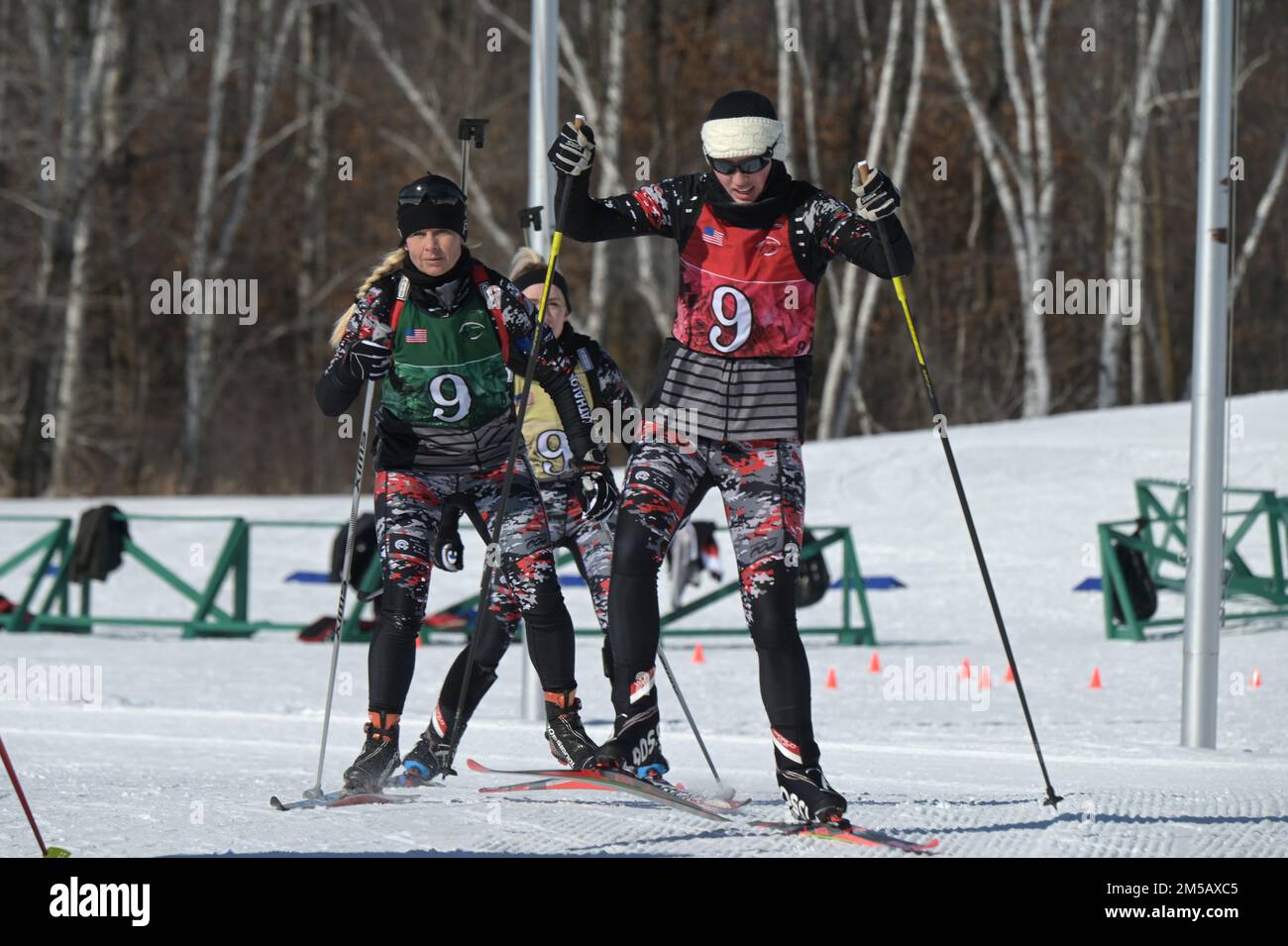 U.S. Army and Air Force members of the North Dakota National Guard from left to right Senior Master Sgt. Danelle Card, of the 119th Wing, 2nd Lt. Kaitlyn Gura, of the 1,188th Air Defense Artillery Regiment, and Spc. Sydney Kautz, of the 188th Engineer Company, cross-country ski a portion of the biathlon patrol race at the Chief of the National Guard Bureau Biathlon Championship held at Camp Ripley, Minn., Feb. 11-17, 2022. The three-member North Dakota team contributed to a second place finish in the women's overall category of the competition with several individual and group event awards in Stock Photo