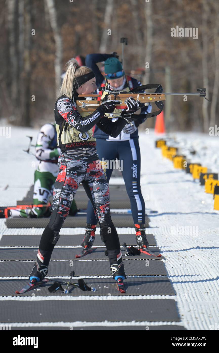 U.S. Army 2nd Lt. Kaitlyn Gura, of the 1,188th Air Defense Artillery Regiment, North Dakota Army National Guard, takes aim at a target on the shooting range of the biathlon patrol race at the Chief of the National Guard Bureau Biathlon Championship held at Camp Ripley, Minn., Feb. 11-17, 2022. She was on the North Dakota team that placed second in the women's overall category of the competition, and second in the combined men's and women's overall category. Stock Photo