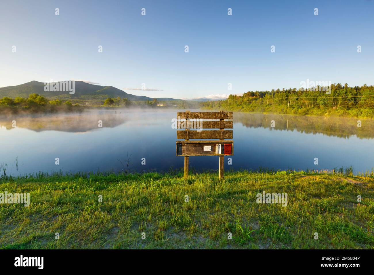 Reflection of Cherry Mountain in Airport Marsh, near Mt Washington Regional Airport, in Whitefield, New Hampshire on a  foggy, cloudless, spring morni Stock Photo