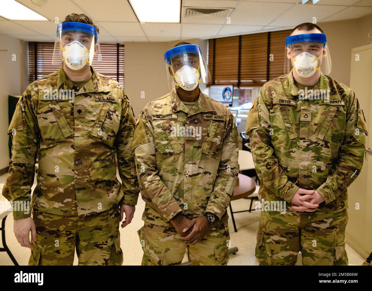 Three combat medics with the 1st Battalion, 175th Infantry Regiment Headquarters and Headquarters Company, pose for a photo at Johns Hopkins Hospital in Baltimore, Maryland. on Feb. 17, 2022. At the direction of Gov. Larry Hogan, up to 1,000 MDNG members were activated to assist state and local health officials with their COVID-19 response to include the distribution of COVID-19 test kits, 20 million KN95 and N95 masks, and other personal protective equipment and to provide support to skilled nursing facilities, hospitals, and testing sites. Stock Photo