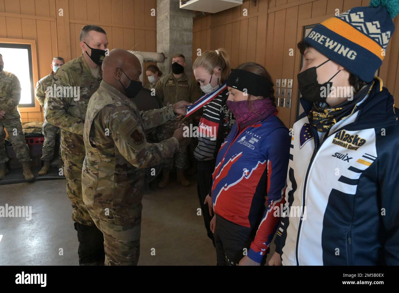 U.S. Air Force Chief Master Sgt. Tony L. Whitehead, the Senior Enlisted Advisor of the National Guard, left, places a first place medal around the neck of Spc. Sydney Kautz, of the 188th Engineer Company, of the North Dakota Army National Guard, during an awards ceremony at the Chief of the National Guard Bureau Biathlon Championship held at Camp Ripley, Minn., Feb. 11-17, 2022. She was also on the four-member North Dakota team that placed second in the women's overall category of the competition with several individual and group event awards in various biathlon events. Stock Photo