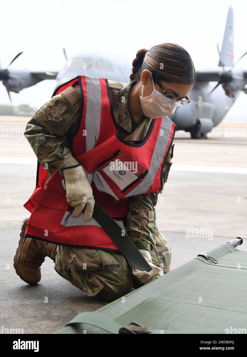 U.S Air Force Airman 1st Class Elizabeth Contreras, 81st Healthcare Operations Squadron medical technician, prepares a stretcher for patients during the National Disaster Medical System Exercise outside the 41st Aerial Port Squadron building at Keesler Air Force Base, Mississippi, Feb. 17, 2022. Keesler's Federal Coordination Center was activated and received more than 20 patients during the exercise scenario, which included the New Madrid Fault erupting, sparking an earthquake to occur in Tennessee causing extensive damage and injuring many people. Members of the 81st Medical Group participat Stock Photo