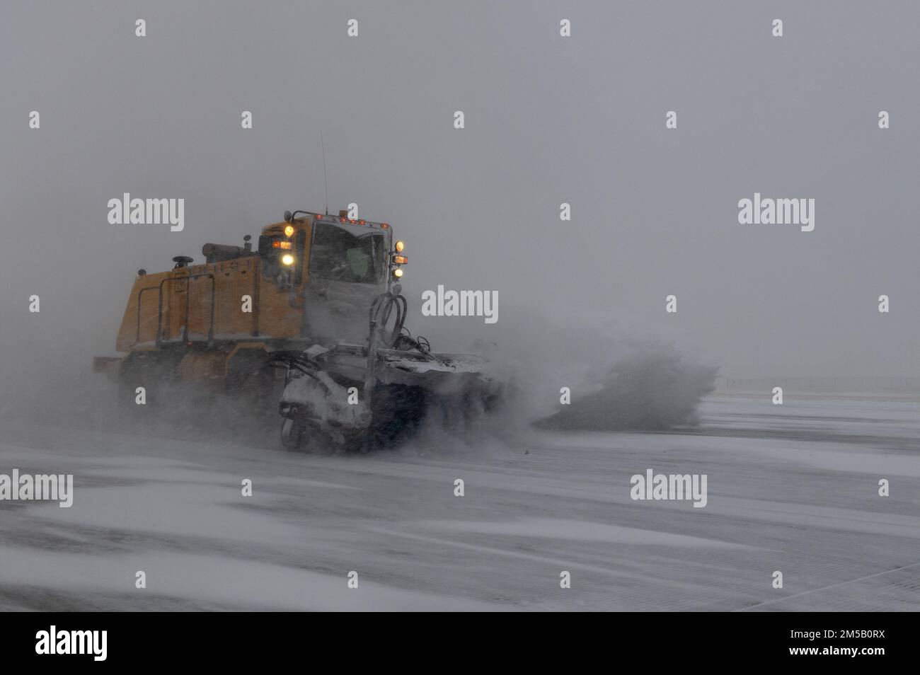 The 22nd Civil Engineering Squadron’s snow removal team clears snow from the flight line Feb. 17, 2022, at McConnell Air Force Base, Kansas. The snow removal team uses a combination of snow plows and brushes to ensure aerial operations can be continue safely. Stock Photo