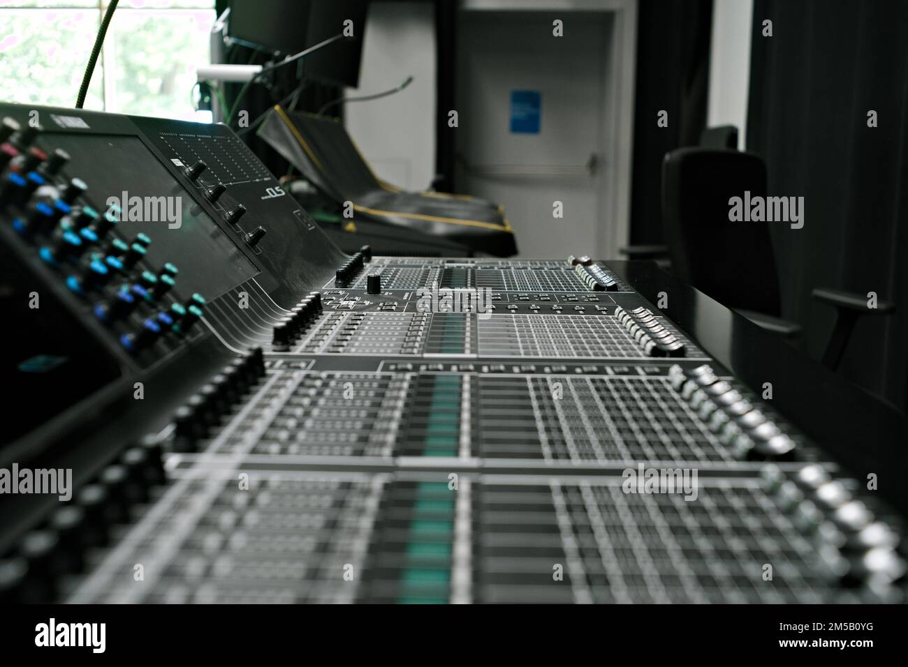 A closeup shot of a professional audio mixer in studio for music production with blur background Stock Photo