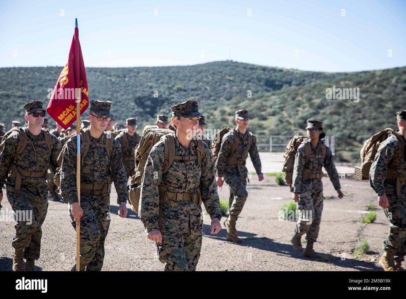 U.S. Marine Corps Lt. Col. Christine M. Houser, the commanding officer of Headquarters and Headquarters Squadron, Marine Corps Air Station Miramar, leads a squadron hike on MCAS Miramar, San Diego, California, Feb. 17, 2022. The squadron conducted a ten-mile conditioning hike to enhance combat fitness, build cohesion, and promote unit camaraderie throughout the squadron. Stock Photo