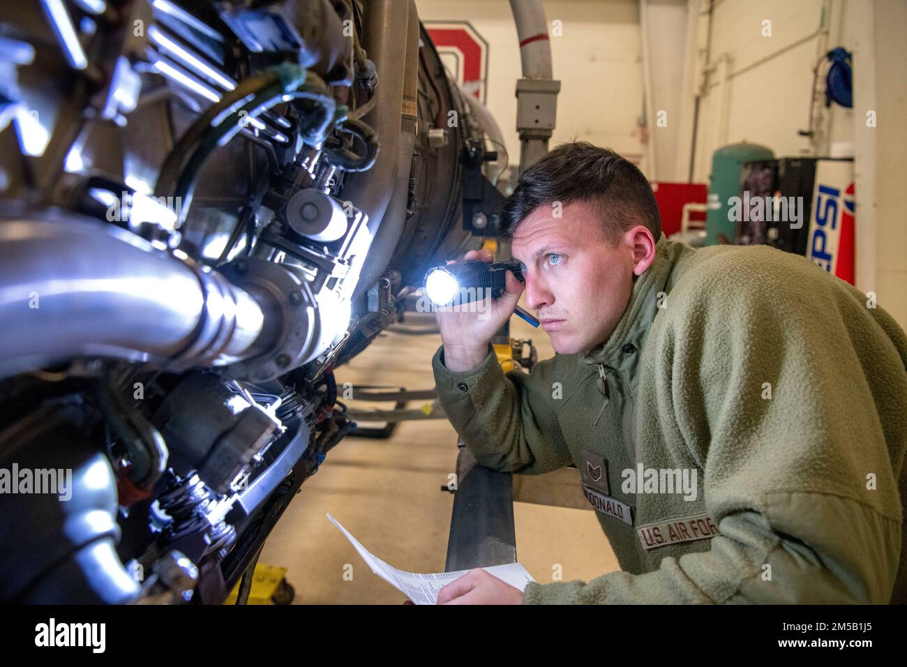 U.S. Air Force Staff Sgt. Tristan McDonald, an aerospace propulsion  technician, assigned to the Ohio National Guard's 180th Fighter Wing,  inspects the engine of an F-16 Fighting Falcon at the 180FW in