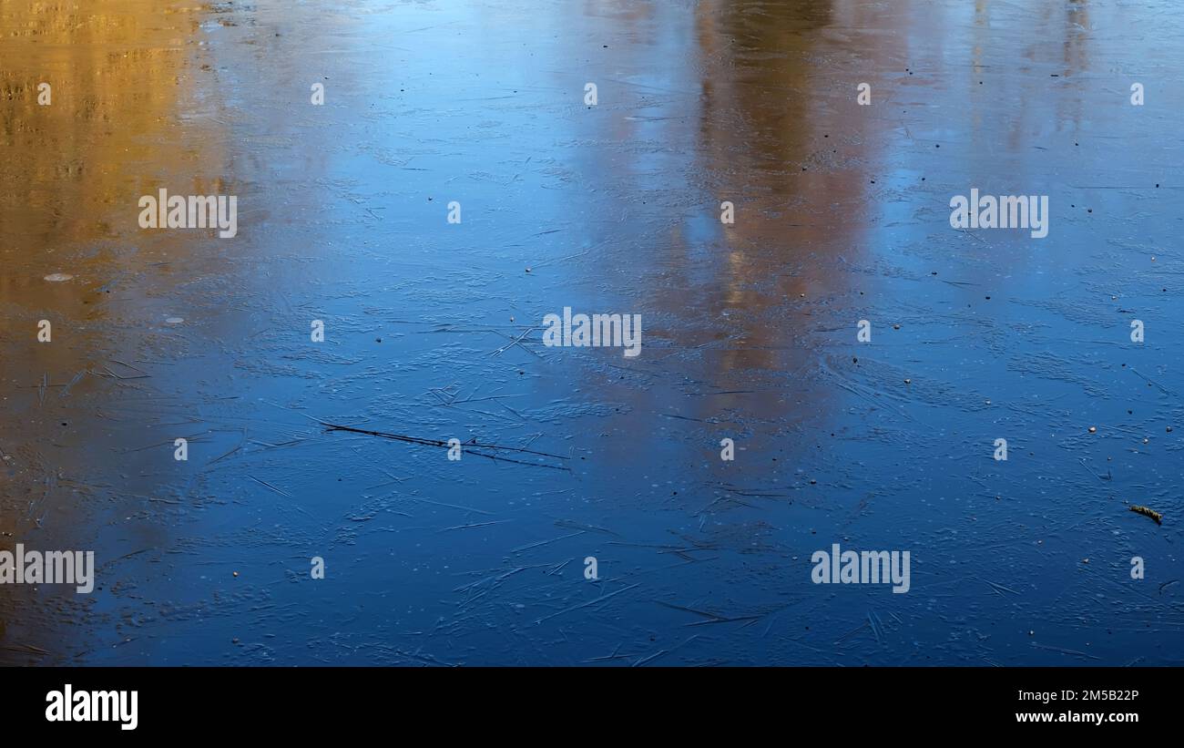 A frozen lake with trees reflected on the ice Stock Photo - Alamy