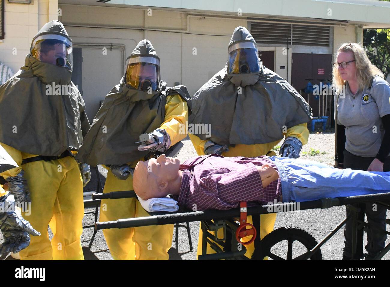 Sailors from Navy Medicine Readiness and Training Command Pearl Harbor triage a simulated contaminated patient as part of the First Receiver Operations Training (FROT) held at Branch Health Clinic Makalapa on February 17, 2022. This yearly requirement teaches Sailors to properly decontaminate patients prior to administering medical care in the event of a Chemical, Biological, Radiological, or Nuclear (CBRN) incident. Stock Photo