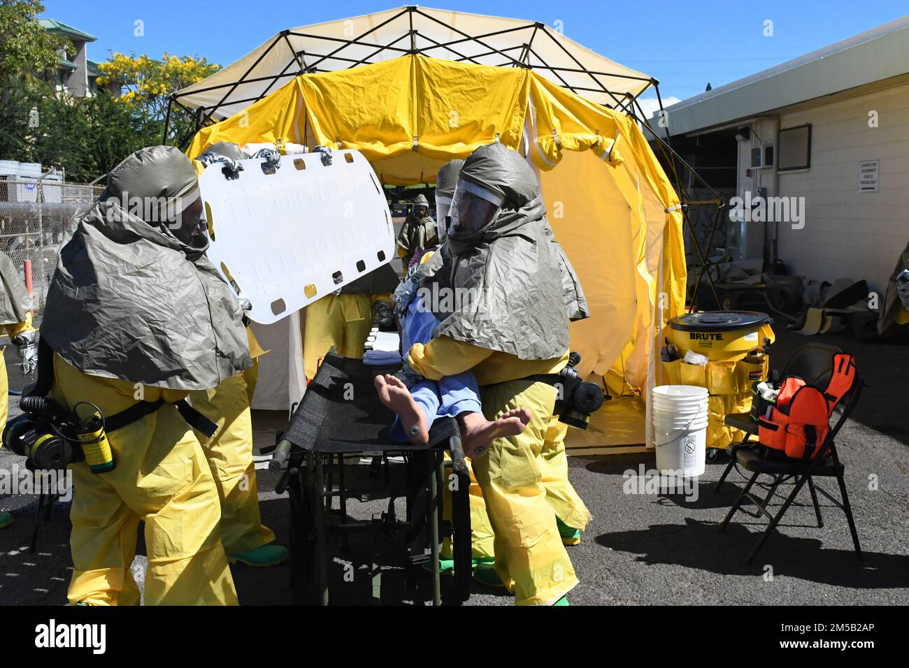 Sailors from Navy Medicine Readiness and Training Command Pearl Harbor triage a simulated contaminated patient as part of the First Receiver Operations Training (FROT) held at Branch Health Clinic Makalapa on February 17, 2022. This yearly requirement teaches Sailors to properly decontaminate patients prior to administering medical care in the event of a Chemical, Biological, Radiological, or Nuclear (CBRN) incident Stock Photo