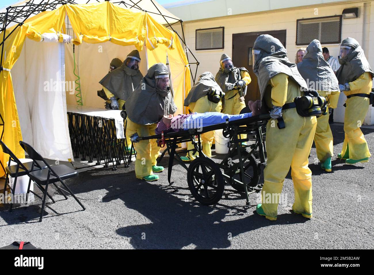 Sailors from Navy Medicine Readiness and Training Command Pearl Harbor triage a simulated contaminated patient as part of the First Receiver Operations Training (FROT) held at Branch Health Clinic Makalapa on February 17, 2022. This yearly requirement teaches Sailors to properly decontaminate patients prior to administering medical care in the event of a Chemical, Biological, Radiological, or Nuclear (CBRN) incident Stock Photo