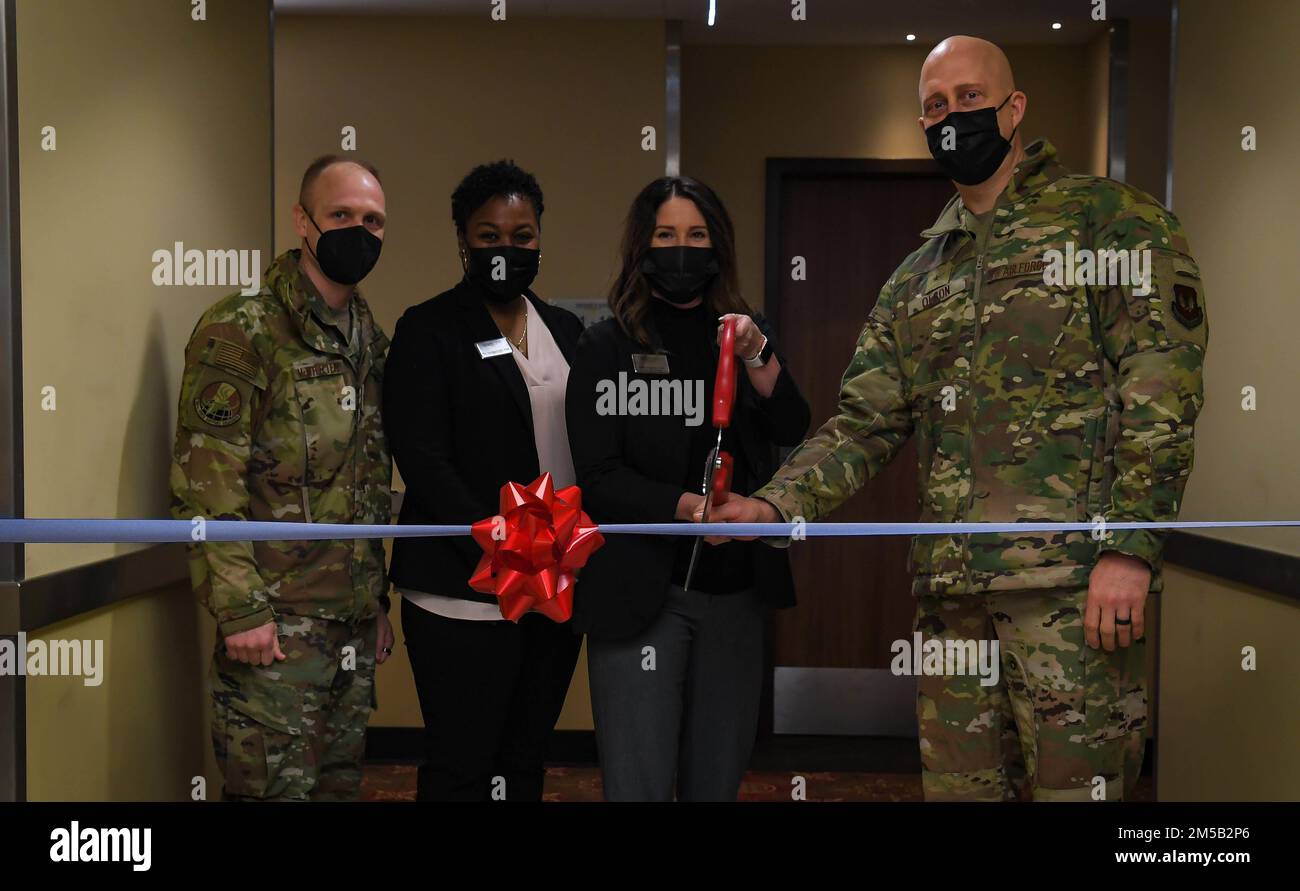 U.S. Air Force Brig. Gen. Josh Olson, 86th Airlift Wing commander, right, and Heidi Payton, 786th Force Support Squadron assistant general manager, second from right, cut the ribbon at a new temporary lodging facility at Ramstein Air base, Germany, Feb. 17, 2022. The TLF allows for an increased capacity of military families to stay on base when they move here from another duty station, while they look for permanent housing. Stock Photo
