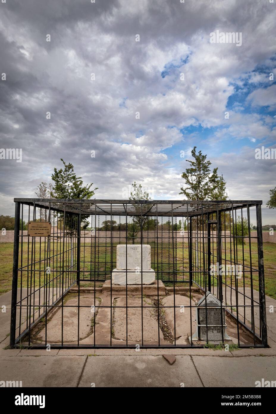 The black stone is the grave of Henry McCarty, aka William H. Bonney, and Billy the Kid at the Old Fort Sumner Cemetery in Fort Sumner, New Mexico. Stock Photo