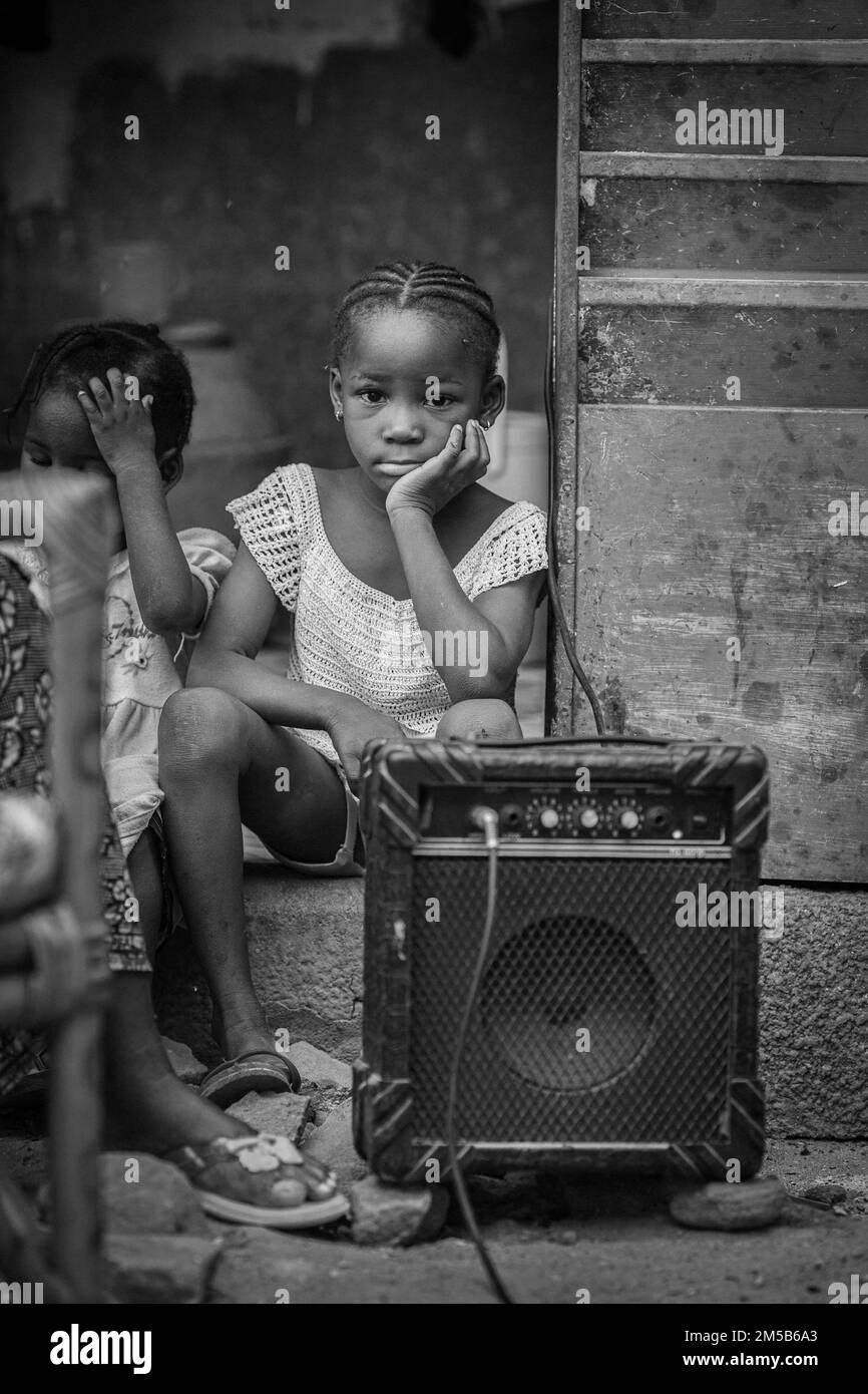 Cute african girl sitting next to a guitar amp in Bamako , Mali , West Africa Stock Photo