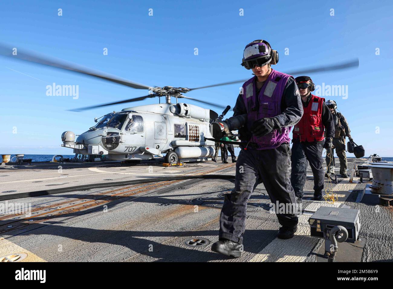 220218-N-ED646-0315- MEDITERRANEAN SEA (Feb. 18, 2022) Sailors secure from refueling an MH-60R Sea Hawk helicopter, assigned to the 'Proud Warriors' of Helicopter Maritime Strike Squadron (HSM) 72, during routine flight operations aboard Arleigh Burke-class guided-missile destroyer USS Gravely (DDG 107), Feb. 18, 2022. Gravely is deployed with the Harry S. Truman Carrier Strike Group on a scheduled deployment in the U.S. Sixth Fleet area of operations in support of naval operations to maintain maritime stability and security, and defend U.S., allied and partner interests in Europe and Africa. Stock Photo