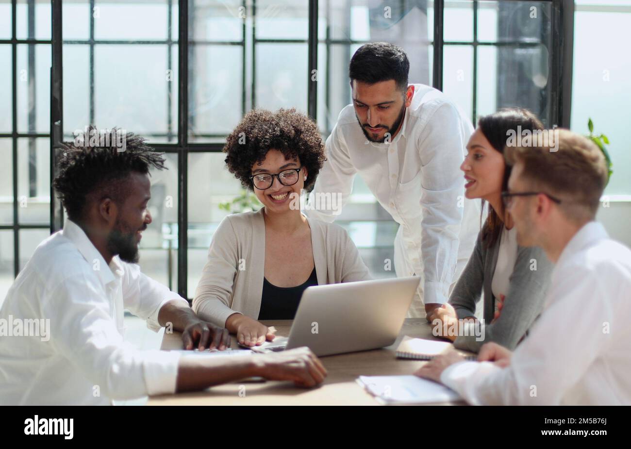 Employees working at computer together, discussing content Stock Photo ...