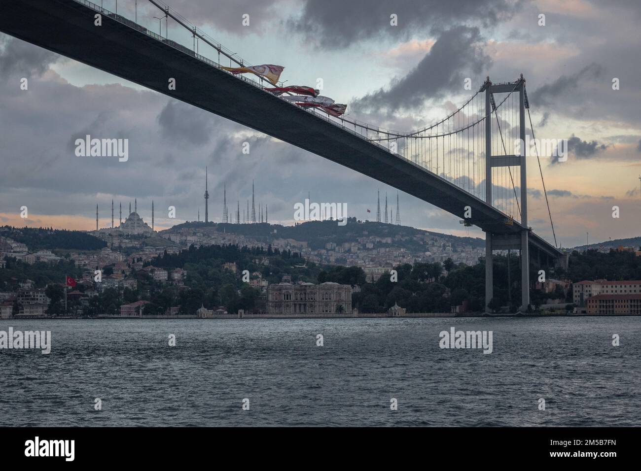A low-angle shot of The 15 July Martyrs Bridge with steel towers and inclined hangers, in Istanbul, Turkey, with a cityscape in the background Stock Photo