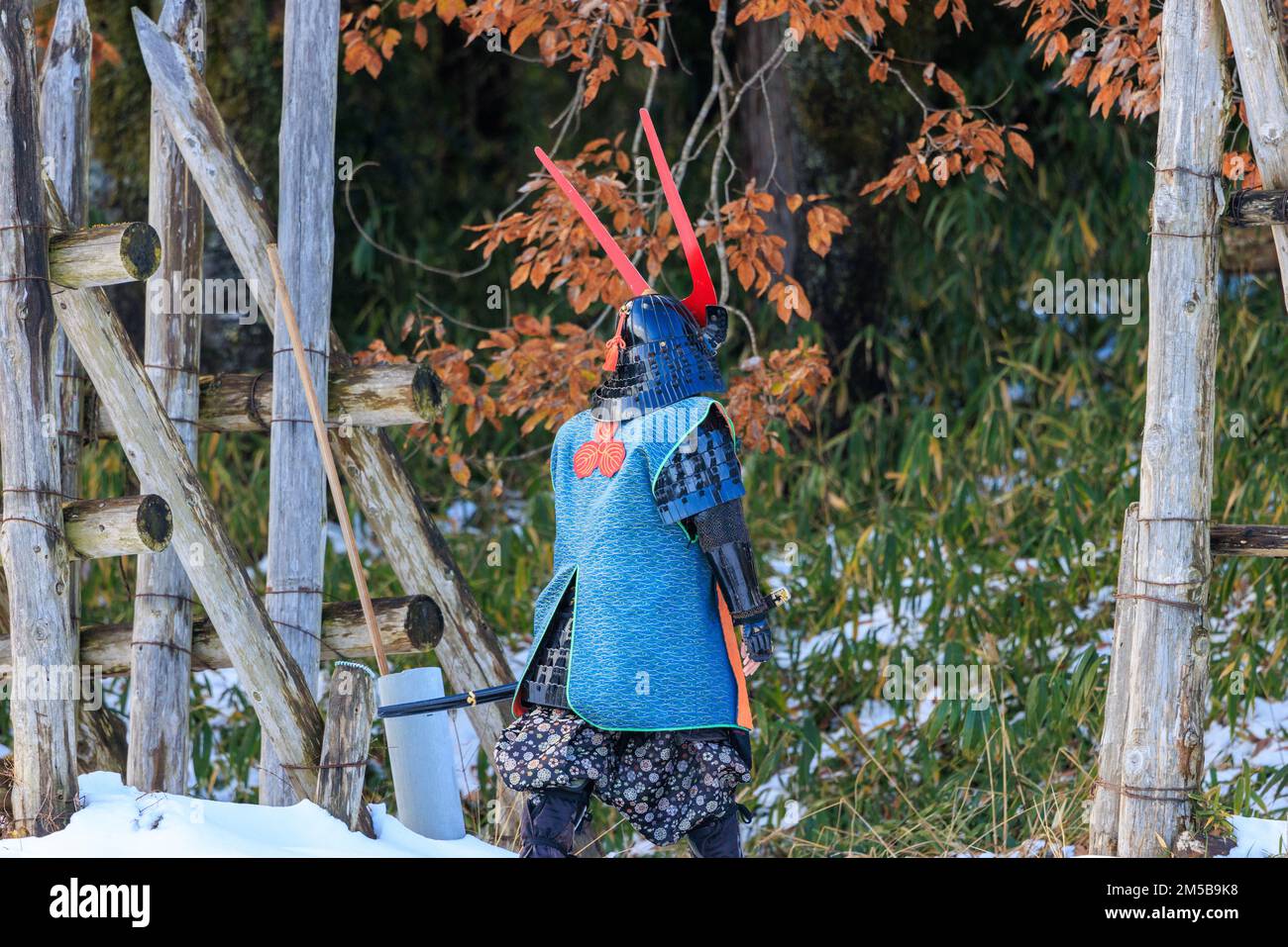 Sekigahara, Japan - December 25, 2022: Man dressed for battle in traditional samurai style walks through snow Stock Photo