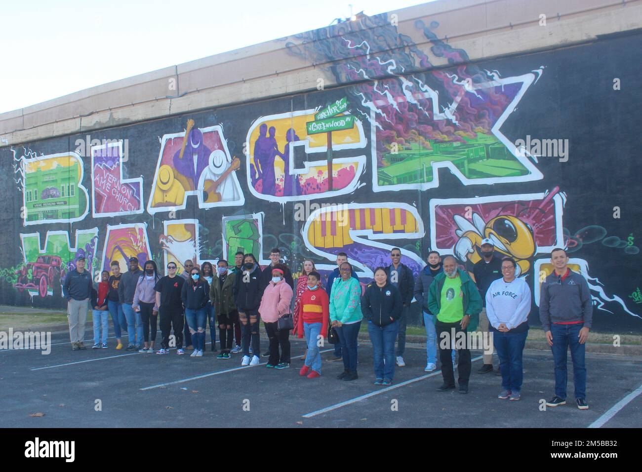 Airmen from the 97th Air Mobility Wing pose in front of the “Black Wall St.” mural outside the Greenwood Cultural Center in Tulsa, Oklahoma, Feb. 18, 2022. The group took part in a tour of the historic Greenwood District, known as Black Wall Street, to engage with the area’s history and culture. Stock Photo