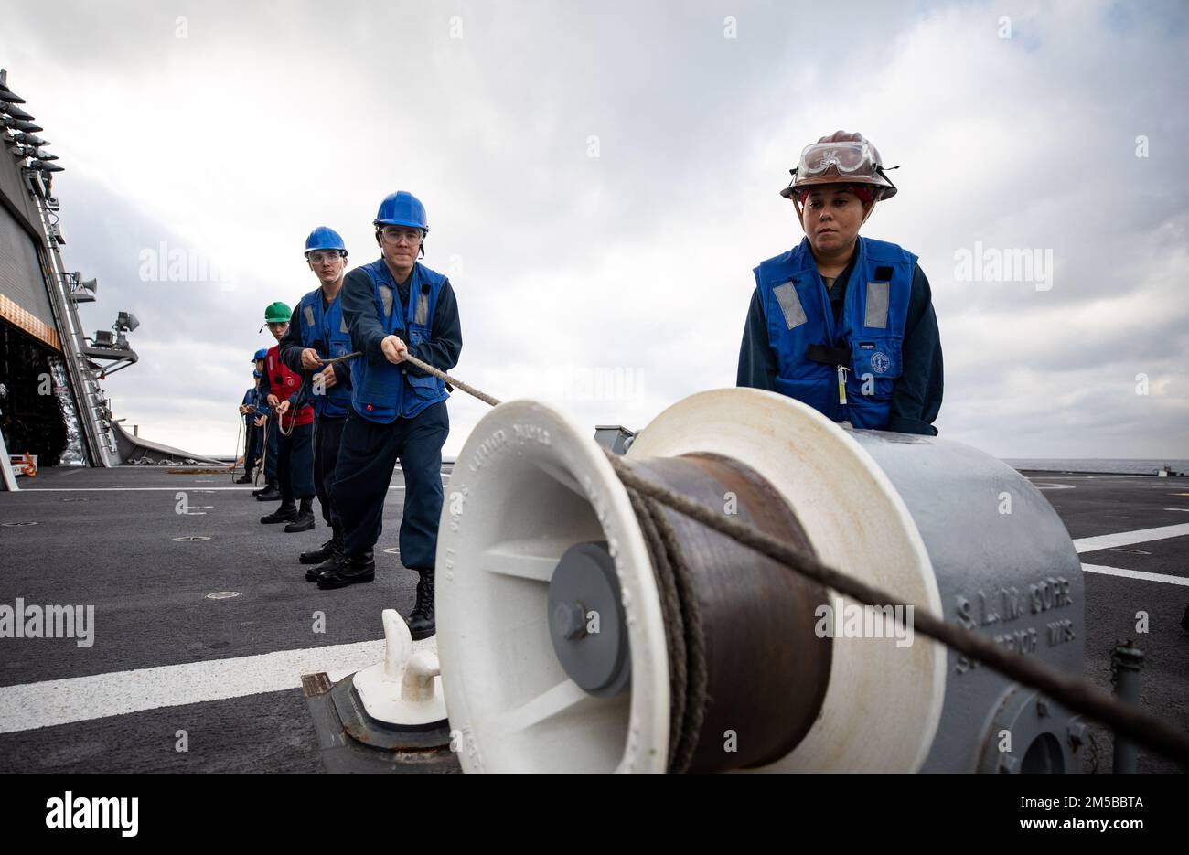 220219-N-LI768-1084  SOUTH CHINA SEA (Feb. 19, 2022) – Sailors heave around on a line aboard the Independence-variant littoral combat ship USS Tulsa (LCS 16) during a replenishment-at-sea. Tulsa, part of Destroyer Squadron (DESRON) 7, is on a rotational deployment, operating in the U.S. 7th Fleet area of operations to enhance interoperability with partners and serve as a ready-response force in support of a free and open Indo-Pacific region. Stock Photo