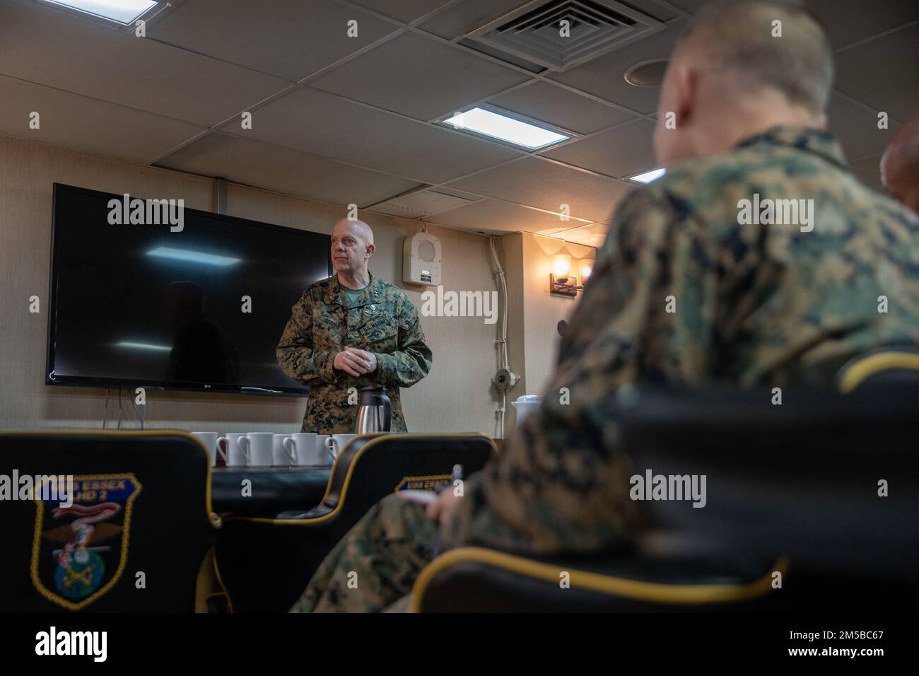 PEARL HARBOR (Feb. 20, 2022) U.S. Marine Corps Gen. David Berger, the Commandant of the Marine Corps, addresses Marines and Sailors assigned to the 11th Marine Expeditionary Unit (MEU), during a distinguished visit aboard Wasp-class amphibious assault ship USS Essex (LHD 2), Feb. 20, 2022. Sailors and Marines of Essex Amphibious Ready Group (ARG) and the 11th MEU are visiting to Joint Base Pearl Harbor-Hickam while operating in U.S. 3rd Fleet. Stock Photo