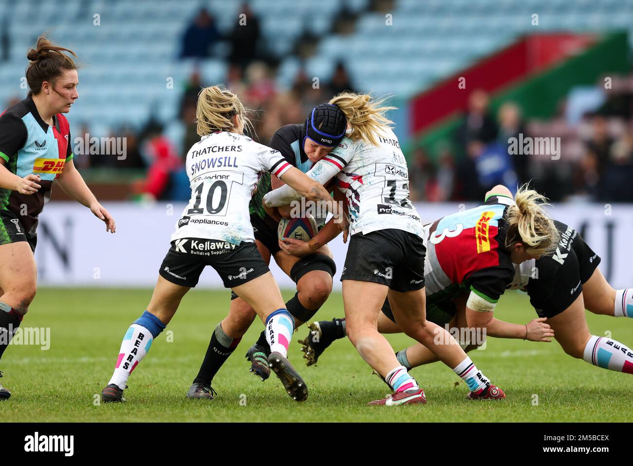 Sarah Bonar of Harlequins Women is doubletackled by Elinor Snowsill and Amber Reed of Bristol