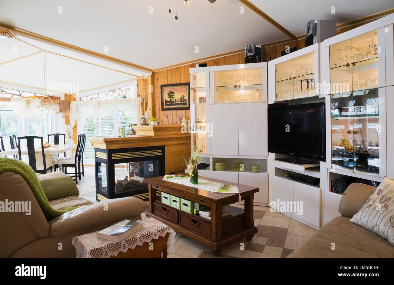 White gloss laminated wall unit and gas fireplace between dining room