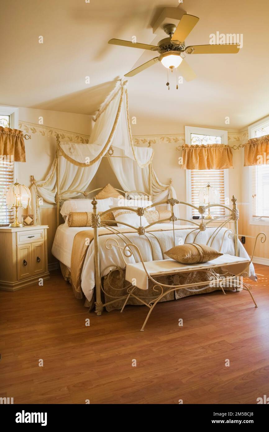 Antique queen size canopy bed with wrought iron headboard and footboard