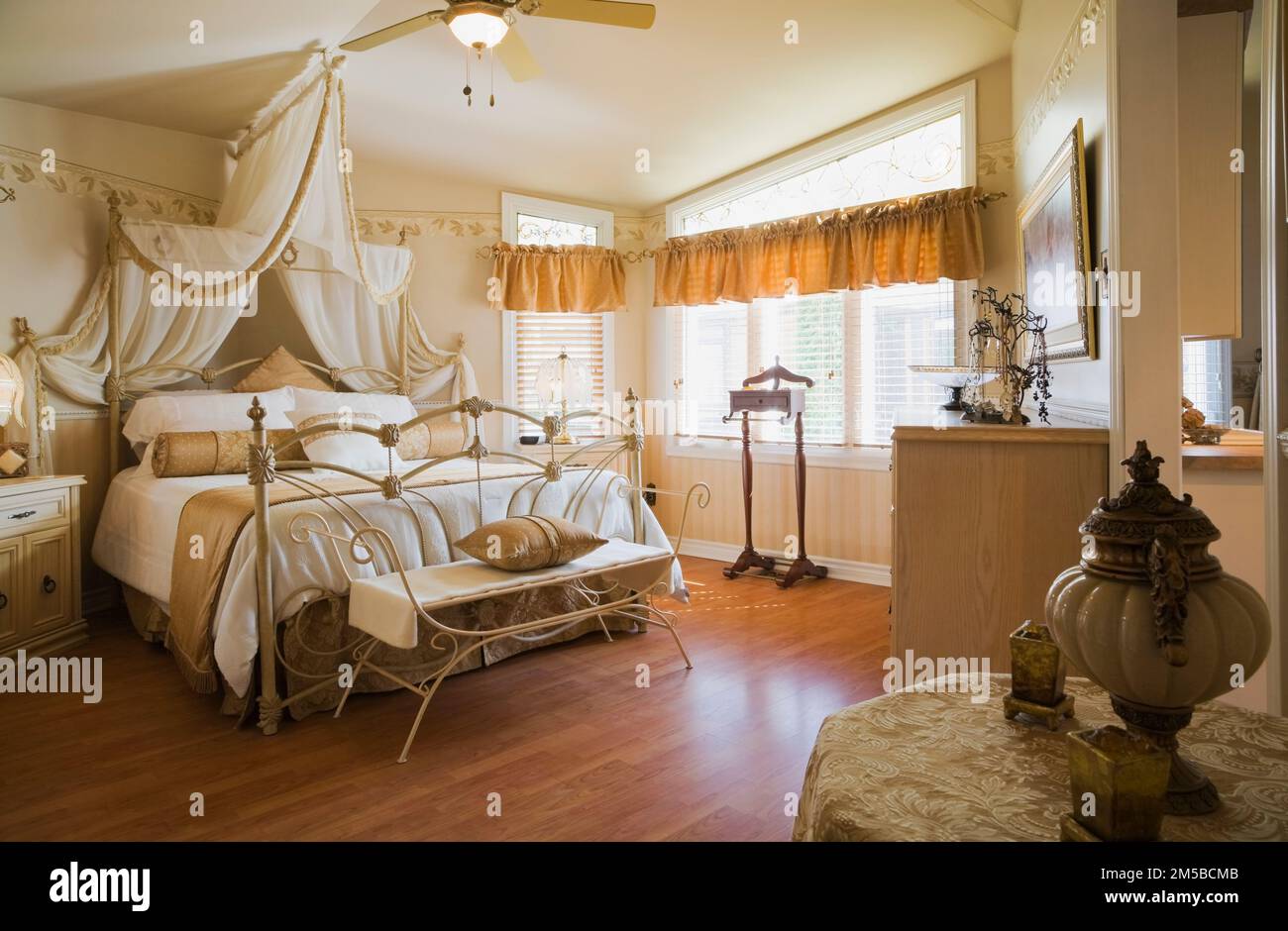 Antique queen size canopy bed with wrought iron headboard and footboard