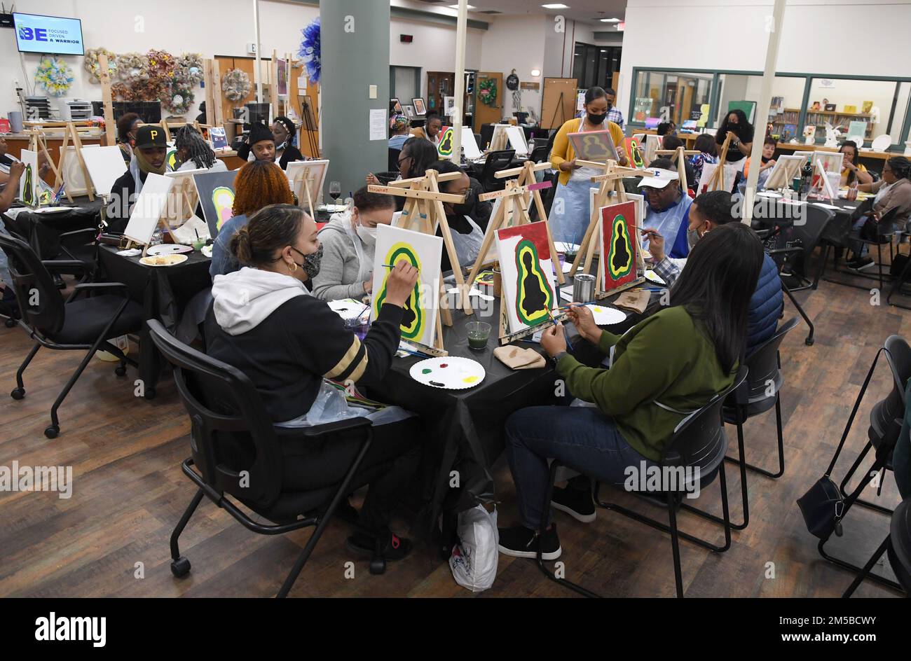 Keesler personnel participate in a paint and sip event inside the