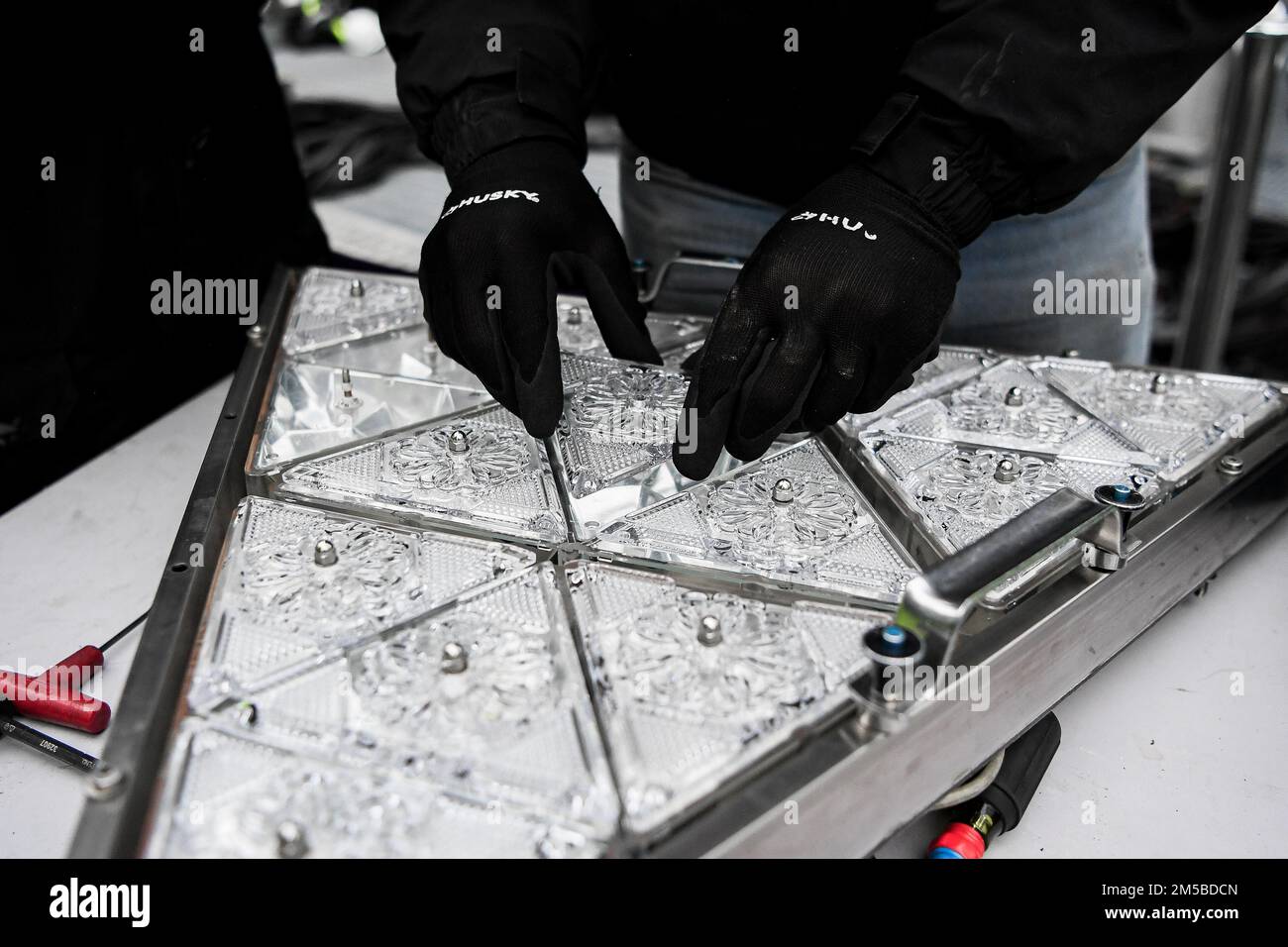 (221227) -- NEW YORK, Dec. 27, 2022 (Xinhua) -- A piece of crystal is put into a larger pattern during the Crystal Times Square New Year's Ball assembly on the roof of One Times Square, New York, the United States, on Dec. 27, 2022. As part of the yearly tradition, replacement of some of the 2,688 Waterford Crystal triangles on the Times Square New Year's Eve Ball started on Tuesday. The ball, 12 feet in diameter and 11,875 pounds in weight, will begin its descent at 11:59 p.m., Dec. 31, starting the countdown of the final seconds of the year and celebrating the beginning of a new year, at the Stock Photo