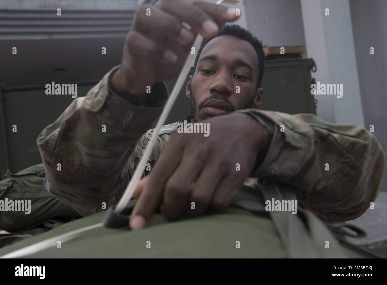 Airman 1st Class Terrell Coleman, 36th Expeditionary Airlift Squadron combat mobility technician, prepares containerized delivery systems (CDS) for air drop training during Exercise Cope South 2022, Feb. 20, 2022, at Bangladesh air force (BAF) Base Bangabandhu, Bangladesh. The CDSs were used by the 36th EAS and BAF to perform air drop training as part of the exercise. Exercise Cope South provides an opportunity for Pacific Air Forces and the Bangladesh armed forces to strengthen their relationship and enhance interoperability, to operate more effectively together when needed. Stock Photo