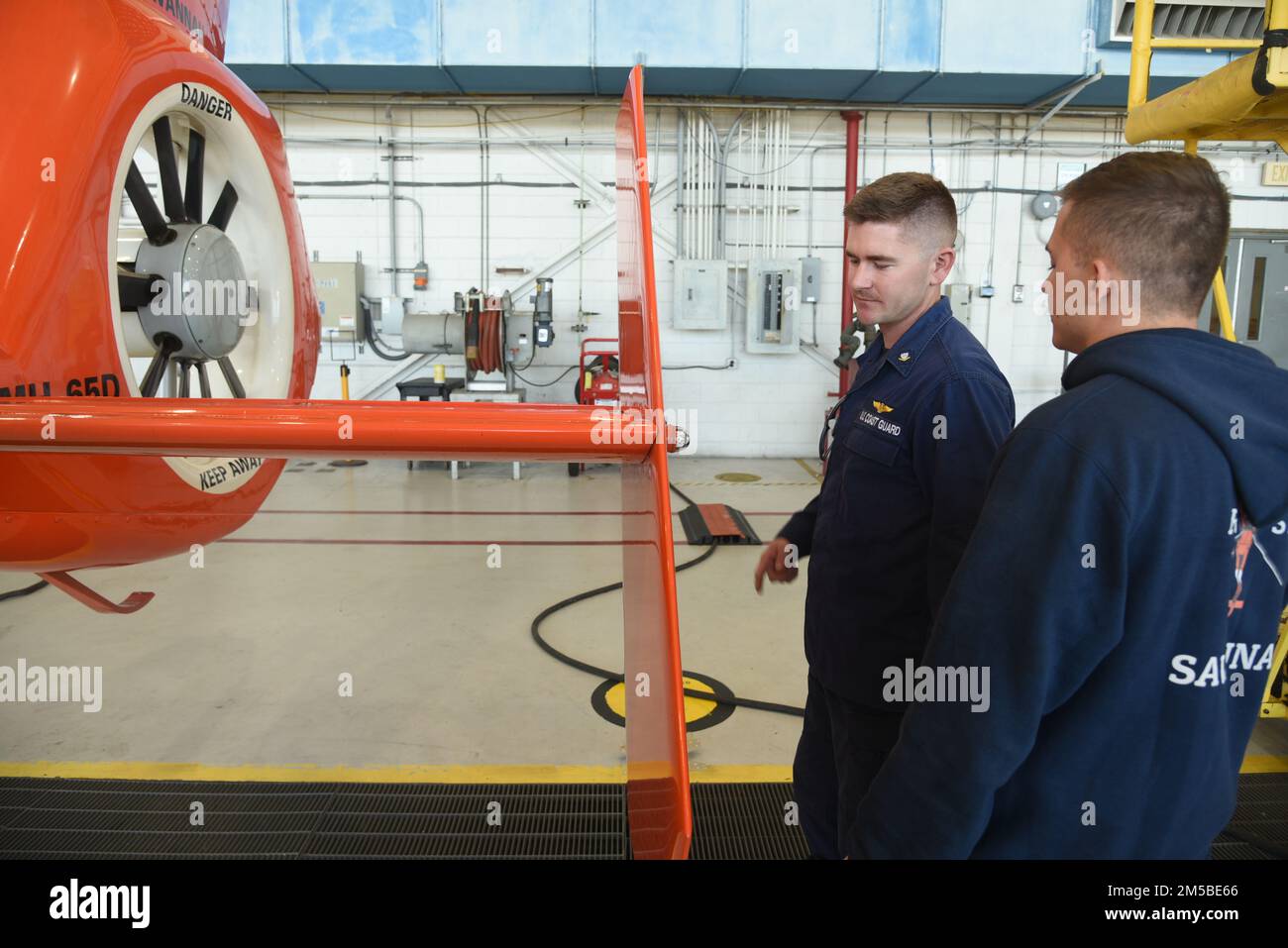 U.S. Coast Guard Petty Officer 3rd Class Bryce Kitchen (left), an aviation maintenance technician, and Airman Michael Rustine, both assigned to the aviation engineering department at Coast Guard Air Station Savannah, Georgia, conduct an inspection on an MH-65 dolphin helicopter, Feb. 21, 2022. Air Station Savannah's area of responsibility cover approximately 450 miles of shoreline from the northern border of South Carolina to Melbourne, Florida. Stock Photo