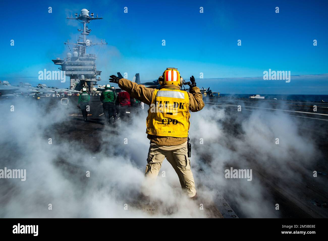 220221-N-DH793-1010 ADRIATIC SEA (Feb. 21, 2022) Chief Aviation Boatswain's Mate (Handling) Carlos Abalos, from Jersey City, New Jersey, directs the pilot of an F/A-18 Super Hornet on the flight deck of the Nimitz-class aircraft carrier USS Harry S. Truman (CVN 75), Feb. 21, 2022. The Harry S. Truman Carrier Strike Group is on a scheduled deployment in the U.S. Sixth Fleet area of operations in support of U.S., allied and partner interests in Europe and Africa. Stock Photo