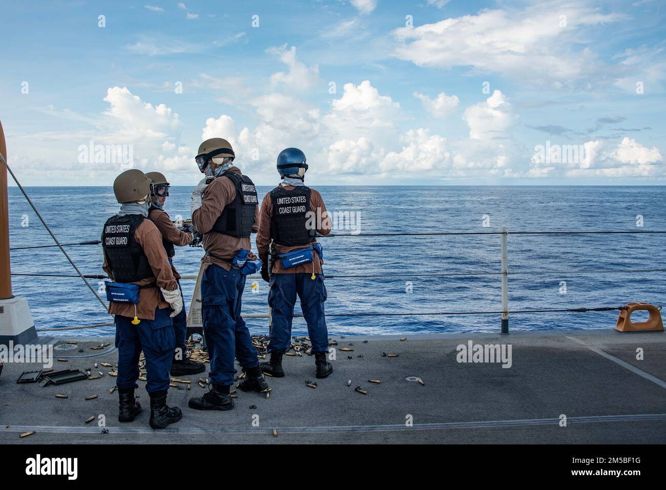 U.S. Coast Guard crew members assigned to the USCGC Stratton (WMSL 752) prepare to fire a .50 caliber machine gun during a gunnery exercise aboard the cutter in the Pacific Ocean, Feb. 22, 2022. The Stratton crew continues to maintain and increase capabilities to ensure a proficient crew while underway in the Pacific region. Stock Photo