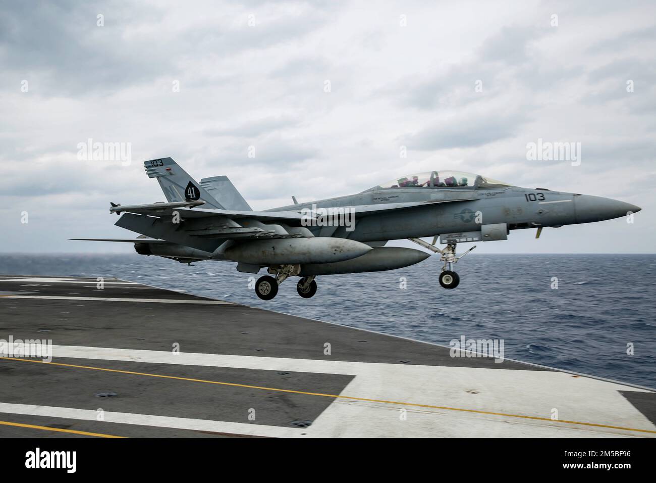 PHILIPPINE SEA (Feb. 22, 2022) An F/A-18F Super Hornet, assigned to the 'Black Aces' of Strike Fighter Squadron (VFA) 41, launches from the flight deck of the Nimitz-class aircraft carrier USS Abraham Lincoln (CVN 72). Abraham Lincoln Strike Group is on a scheduled deployment in the U.S. 7th Fleet area of operations to enhance interoperability through alliances and partnerships while serving as a ready-response force in support of a free and open Indo-Pacific region. Stock Photo