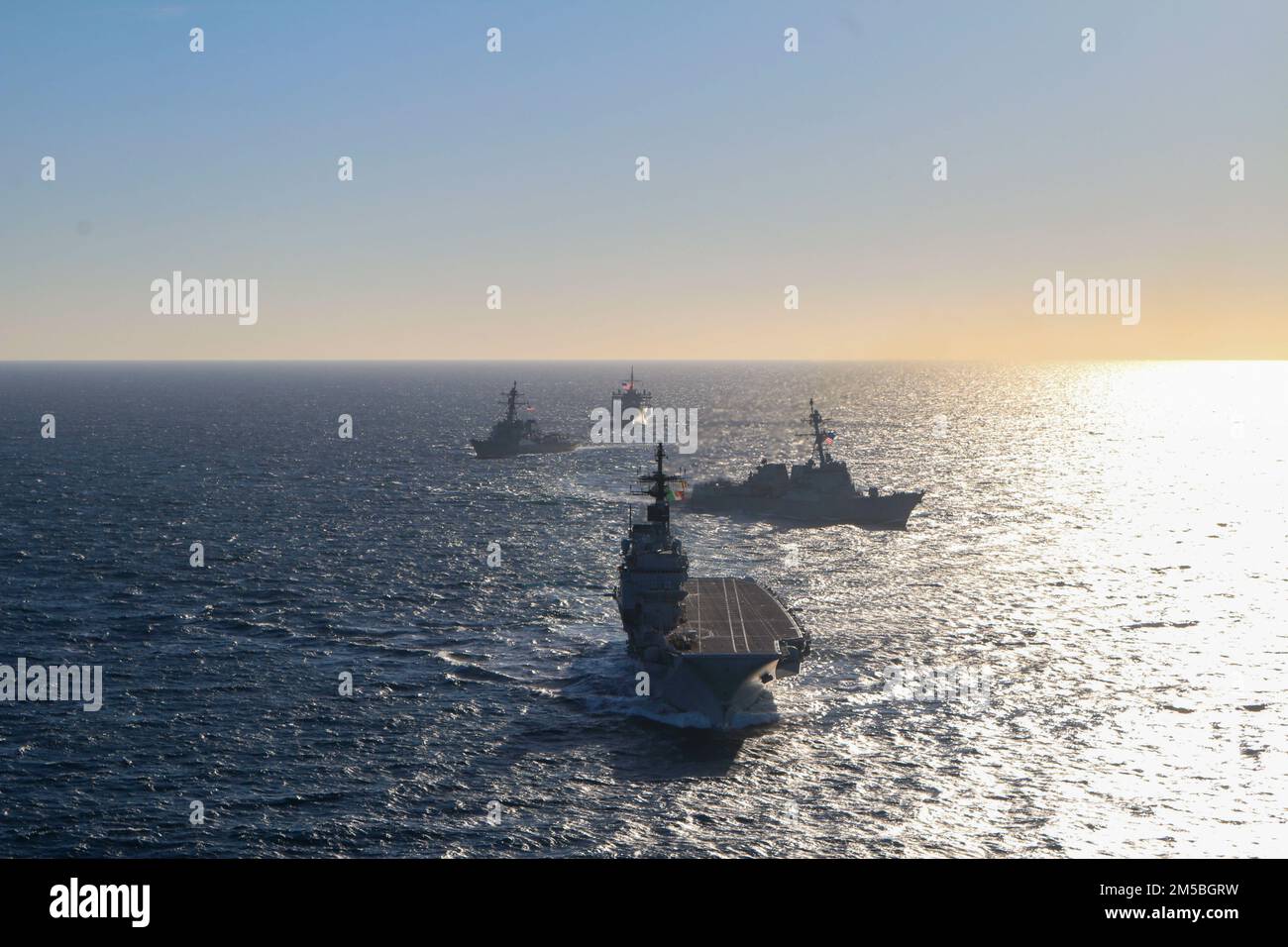 220222-N-NO901-0001 BAY OF CADIZ (Feb. 22, 2022) Italian aircraft carrier ITS Giuseppe Garibaldi leads the formation in a photo exercise with Arleigh Burke-class guided-missile destroyers USS Forrest Sherman (DDG 98) and USS Roosevelt (DDG 80) and Blue Ridge-class command and control ship USS Mount Whitney (LCC 20), Feb. 22, 2022. USS Forrest Sherman is on a regularly scheduled deployment conducting routine operations in the U.S. Sixth Fleet area of operations. Stock Photo