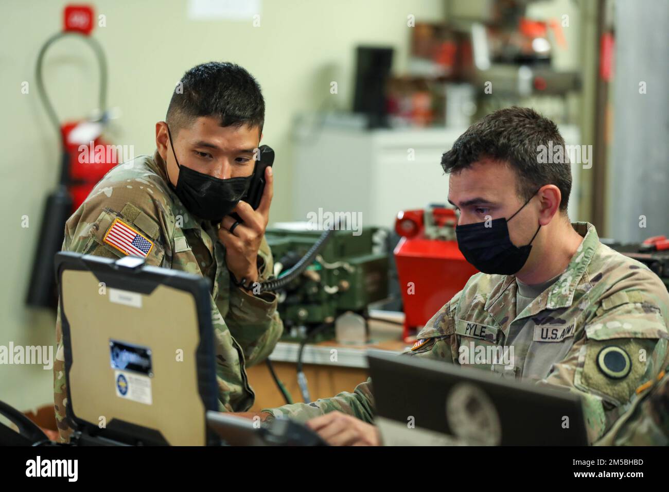 U.S. Army Sgt. Jimmy Nguyen (left), signal operations support specialist, and Sgt. Joseph Pyle (right), air traffic control operator assigned to America’s First Corps, establish communications aboard the USNS City of Bismarck at Naval Base Guam, Feb. 22, 2022. Partnered with the Joint Force, I Corps is conducting a training operation in Guam that enhances readiness, showcases joint interoperability and exercises distributed mission command in the Pacific. Stock Photo
