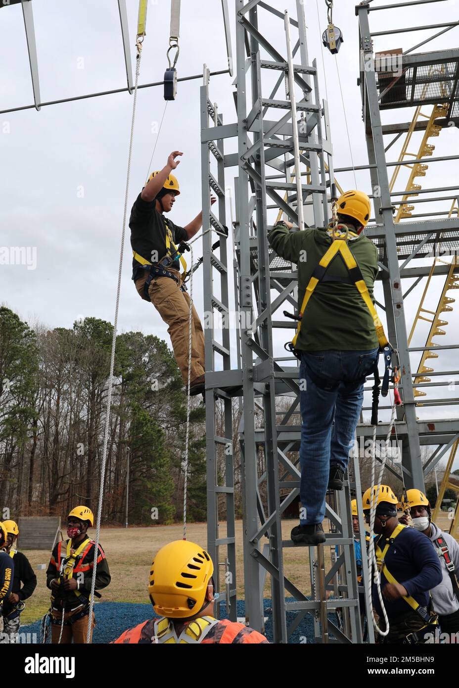 220222-N-OH262-0499--FORT EUSTIS, Va. (February 22, 2022)-- Newly hired Civil Service Mariners (CIVMAR) demonstrate the proper use of safety gear to transit aloft aboard a ship, while attending Basic Training at Military Sealift Command Training Center East on Joint Base Langley-Fort Eustis, Virginia, Feb. 22. The training was part of the MSC Fall Protection curriculum, which must be successfully completed prior to sailing in MSC's fleet of ships. Stock Photo