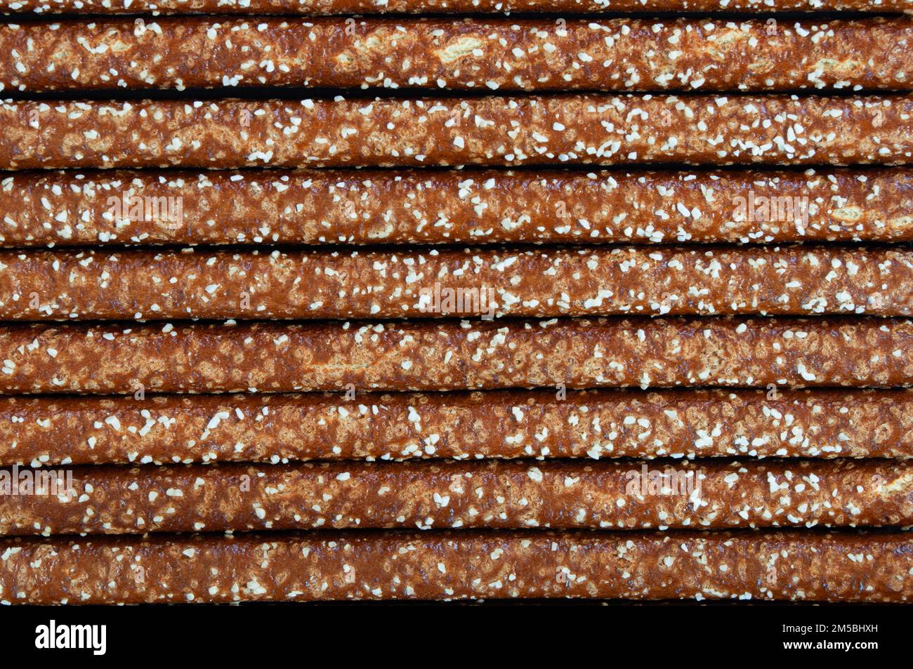 Straight pretzel sticks lined up, background Stock Photo