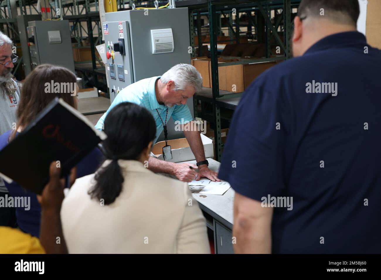 Warehouse supervisor, Ken Brockett, demonstrates proper procedure
