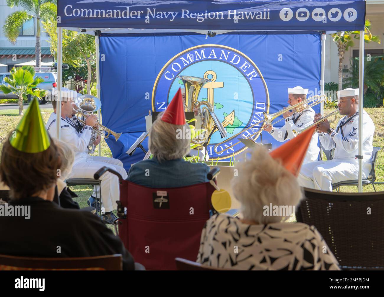 Leihano Senior Living Community residents attend a concert by U.S. Pacific Fleet Band Brass Quintet 'Harbor Brass' in Kapolei, Hawaii Feb. 23, 2022. The band performed musical numbers for retired U.S. Air Force Col. Bruce Hunt and his friends and family in celebration of his 103rd birthday. Stock Photo