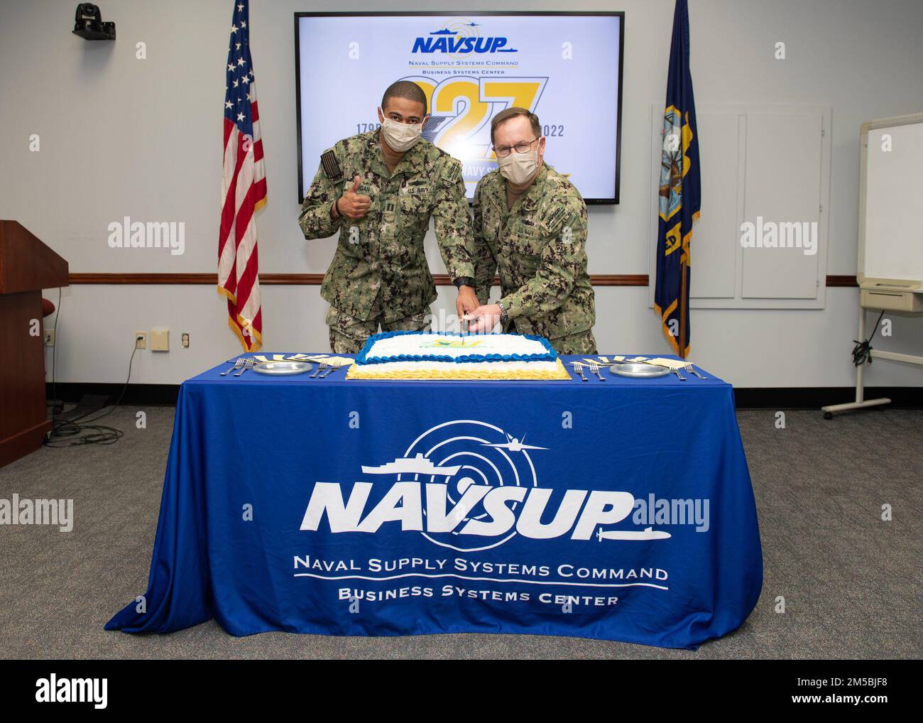 220223-N-PX557-0020  MECHANICSBURG, Pa.  (February 23, 2022)  Lt. Terry Hogan, project officer, assigned to Naval Supply Systems Command (NAVSUP) Business Systems Center (BSC), and Capt. Gene Cash, commanding officer, NAVSUP BSC, participate in a cake-cutting ceremony commemorating the 227th birthday of the U.S. Navy Supply Corps. Military members serving in the Supply Corps are trained and employed in supply chain management, operational logistics, contract management, financial management, operations research, and business enterprise management. The broad responsibilities of the Supply Corps Stock Photo