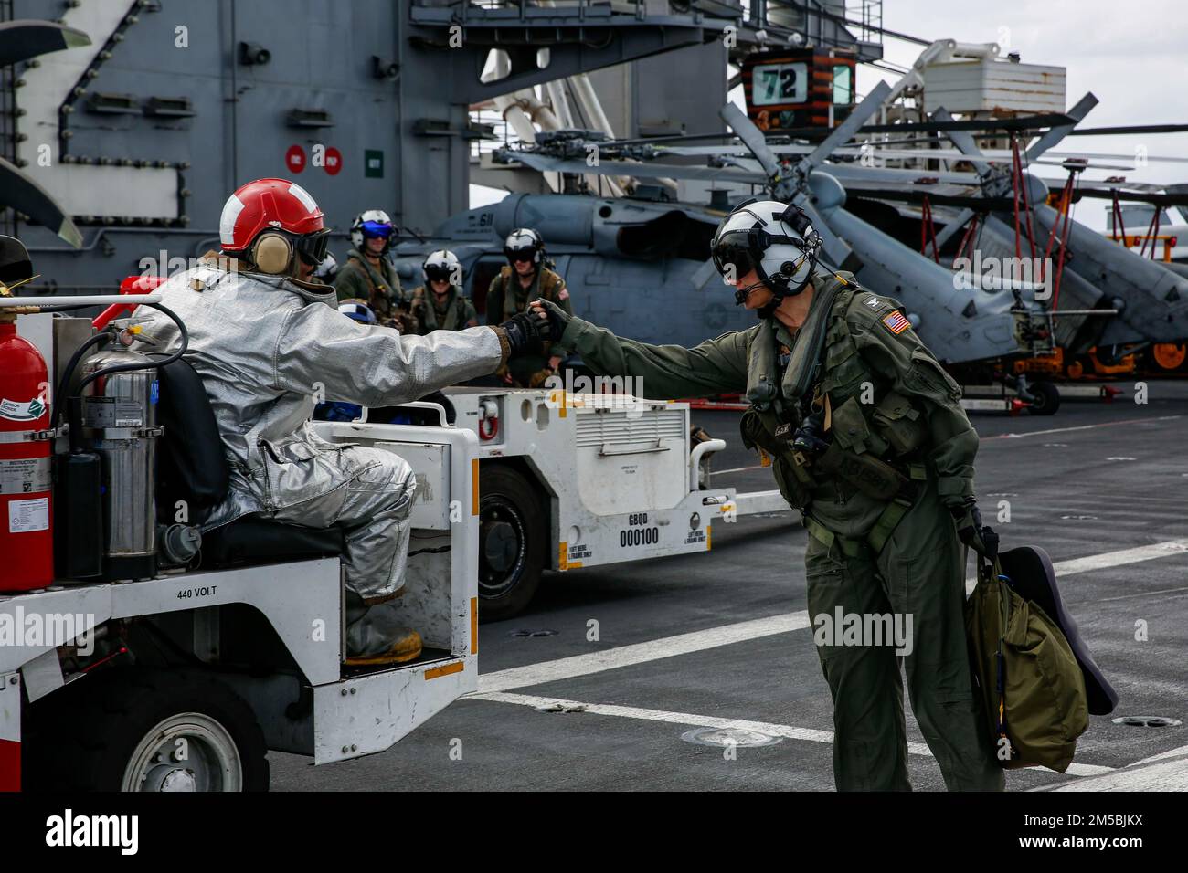 PHILIPPINE SEA (Feb. 23, 2022) Capt. Amy Bauernschmidt, right ...